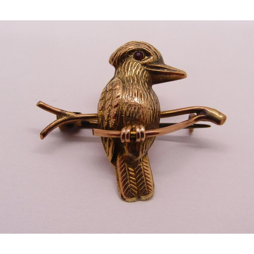 1271 - 9ct garnet bar brooch, 2.3g and a further yellow metal brooch in the form of a kookaburra perched on... 