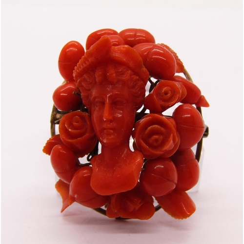 1274 - 19th century carved coral brooch depicting a maiden amidst flowers, 11.4g, together with a coral sti... 