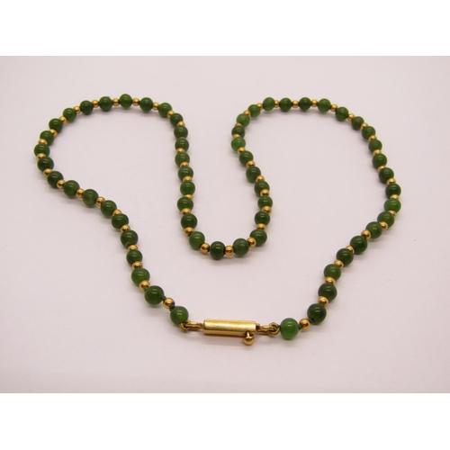 1310 - Green hardstone (possibly jade) and yellow metal bead necklace with clasp stamped '750 CBLd', togeth... 