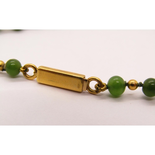 1310 - Green hardstone (possibly jade) and yellow metal bead necklace with clasp stamped '750 CBLd', togeth... 