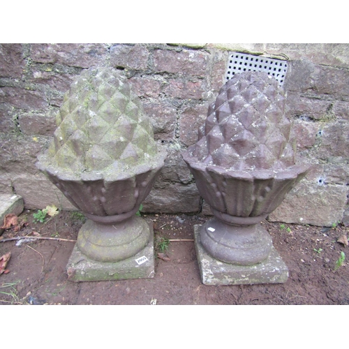 2055 - A pair of weathered cast composition stone pineapple pier cap finials 60 cm high approx, together wi... 