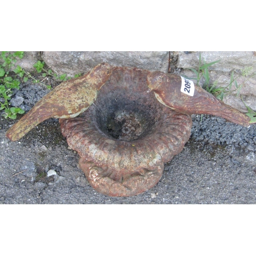 2091 - A small weathered cast iron bird bath in the form of a flared foliate urn with birds surmount, 22 cm... 