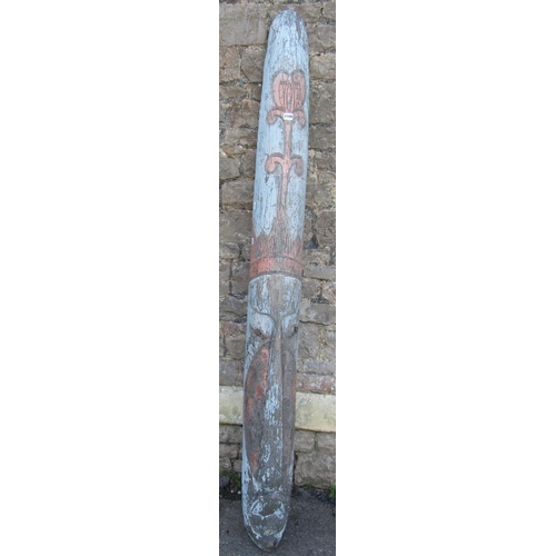 2108 - A weathered painted and distressed wooden elongated tribal mask 194 cm x 20 cm