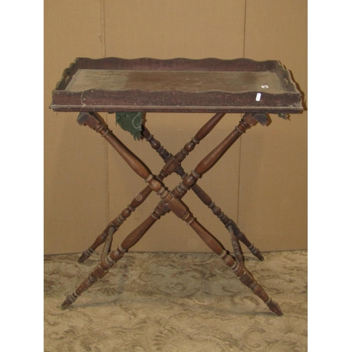 2180 - A 19th century  mahogany butlers tray of rectangular form raised on a folding turned stand, together... 