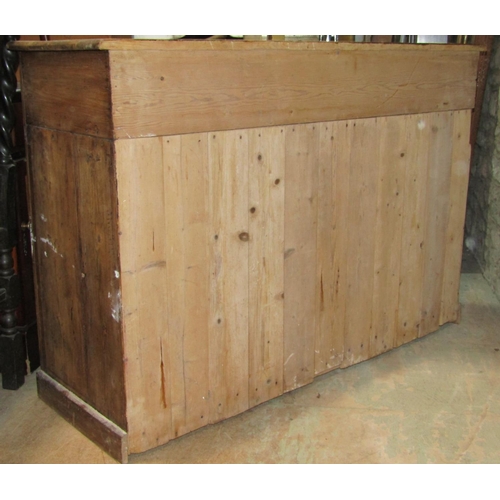 2190 - A rustic stripped pine kitchen dresser base fitted with two frieze drawers over an open shaped shelf... 