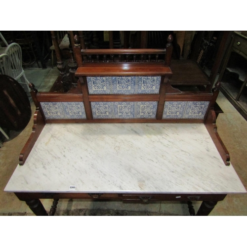 2203 - A late Victorian walnut marble top washstand with raised blue and white transfer printed floral tile... 