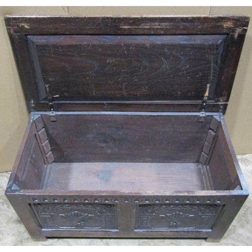 2204 - A reproduction old English style oak coffer with hinged lid, the front elevation with fluted frieze ... 