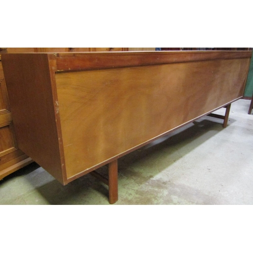 2238 - A White & Newton Ltd long and low retro teak sideboard enclosed by two doors and three long drawers,... 