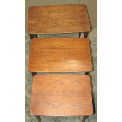 2245 - A nest of three retro Danish teak occasional tables raised on moulded tapered supports, smallest exa... 