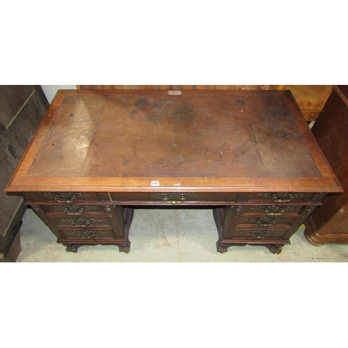 2257 - A 19th century oak kneehole twin pedestal desk with inset leather top over an arrangement of nine fr... 