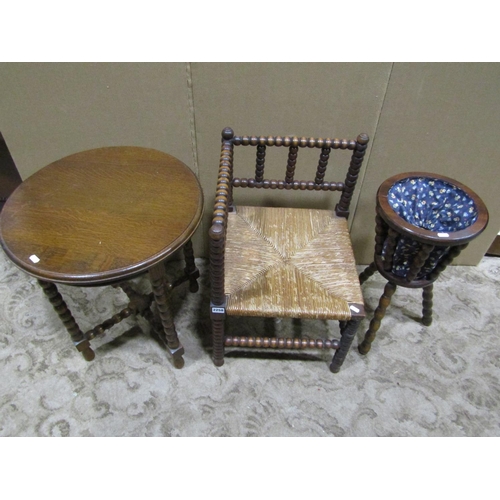 2258 - A rush seated bobbin turned corner chair together with an oak occasional table with circular top and... 