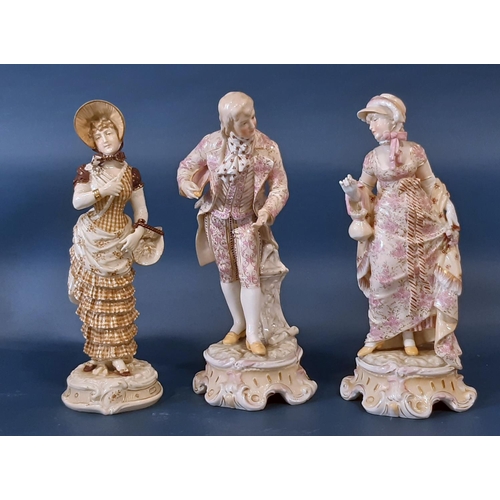 1003A - A pair of 19th century German porcelain figures in pink floral costumes and one other figure, 27cm h... 