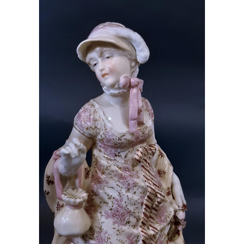 1003A - A pair of 19th century German porcelain figures in pink floral costumes and one other figure, 27cm h... 