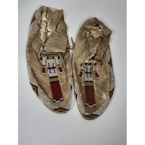 1580 - A collection of vintage Native North American style leather and beadwork including beaded moccasins,... 