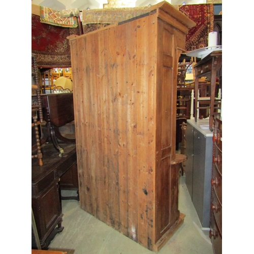 2273 - A substantial reclaimed pine settle with panelled framework, hinged box seat, shaped canopy and carv... 