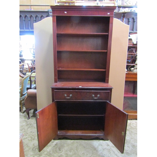 2285 - A reproduction Georgian style mahogany library bookcase with recessed open adjustable shelves over a... 