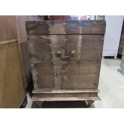 2298 - A weathered teak chest with hinged lid and brass fittings raised on an associated stand, 99cm x 67cm... 