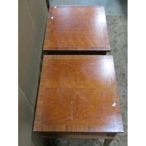 2306 - A pair of reproduction cherry wood low side/lamp tables, each with frieze drawer, rosewood cross ban... 