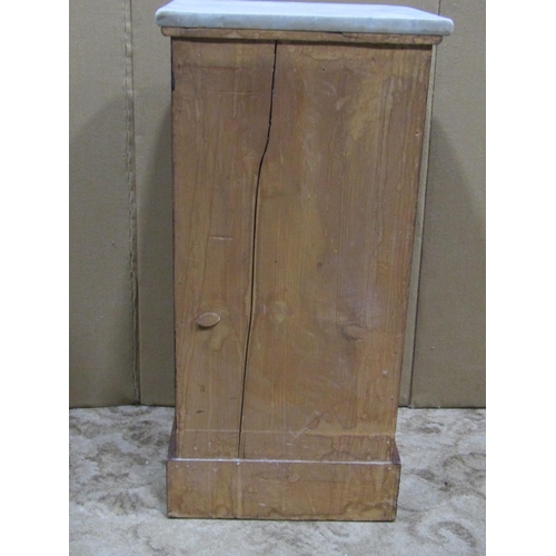 2315 - A Victorian mahogany bedside cupboard with loose white marble top over a rectangular panelled door s... 