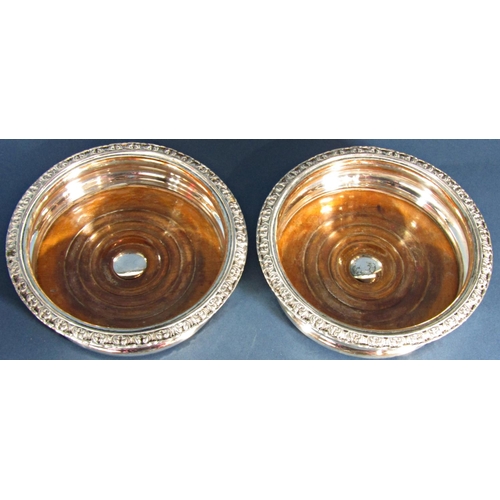 1193 - A pair of Edwardian silver plated wine coasters, 15cm diam.