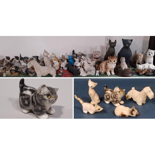 1090 - A large collection of whimsical cats and dogs including a Winstanley cat, three Doulton figures, Wad... 