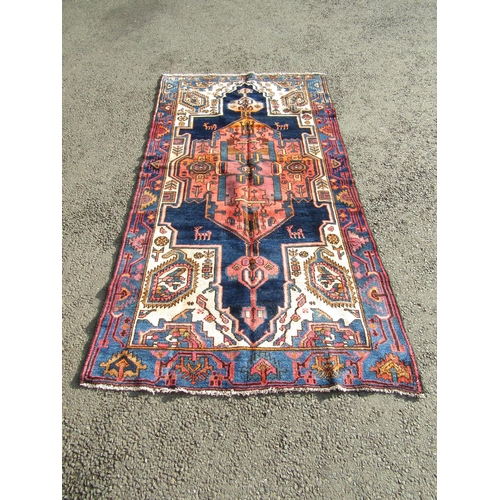 2530 - A North West Persian Viz rug with a large central elongated medallion with stylised flowers and anim... 