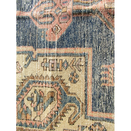 2530 - A North West Persian Viz rug with a large central elongated medallion with stylised flowers and anim... 