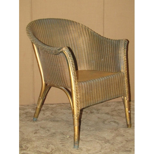 2333 - A pair of vintage Lloyd Loom chairs with swept arms in gold colourway together with one other simila... 