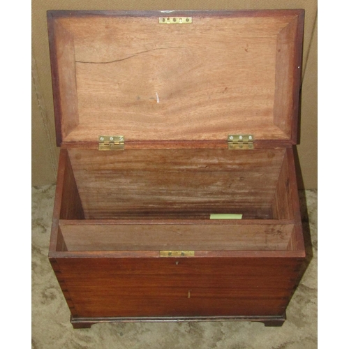 2357 - A small mahogany box with hinge lid enclosing a partially segmented interior and set on bracket feet... 