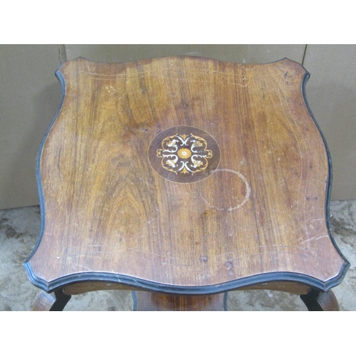 2358 - An inlaid Edwardian rosewood two tier occasional table with serpentine moulded outline and raised on... 