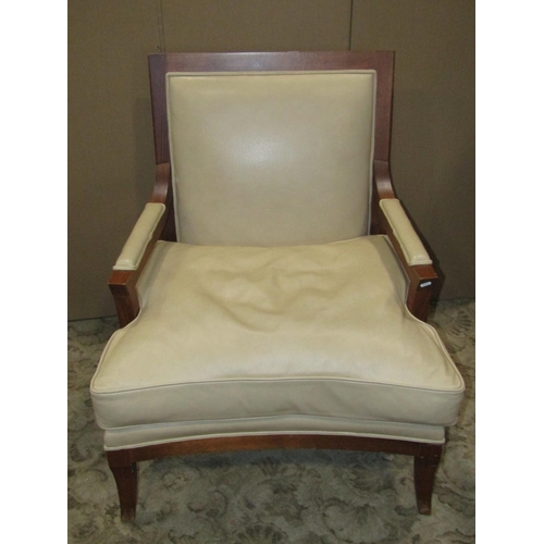 2372 - A substantial open armchair with wide generous seat, upholstered in beige coloured leather with loos... 