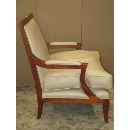 2372 - A substantial open armchair with wide generous seat, upholstered in beige coloured leather with loos... 