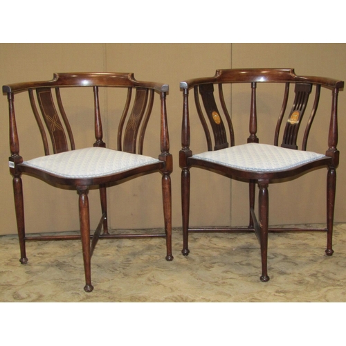 2398 - Two Edwardian mahogany corner chairs with inlaid detail raised on simple turned tapered supports uni... 