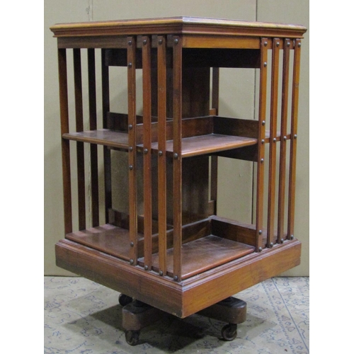 2446 - An Edwardian walnut floorstanding revolving bookcase of square cut form 50 cm square approx x 86 cm ... 