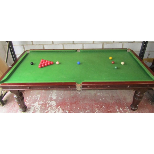 2661 - A late 19th century mahogany snooker table/dining table, the slate base raised on four turned and fl... 