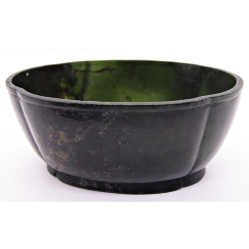 1541 - Chinese dark green jadeite bowl with signature to base, on a rosewood stand, 8cm max