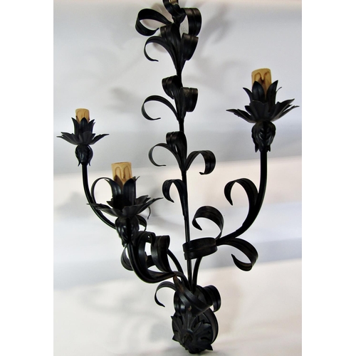 1643 - A pair of scrolled wrought iron wall sconces with three branches and foliate detail, 76 cm long