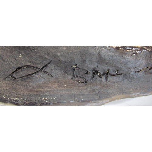 1678 - A bronze finished recumbent cheetah initialled B M below, resting on an oak block, 36cm wide approx.