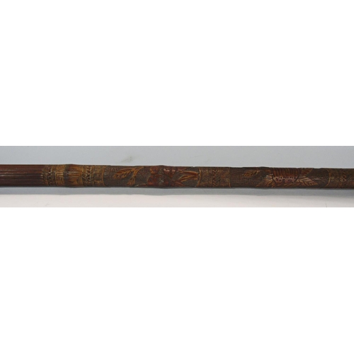 1682 - A intricately carved South East Asian bamboo pole 195cm long together with an ebony walking cane, an... 