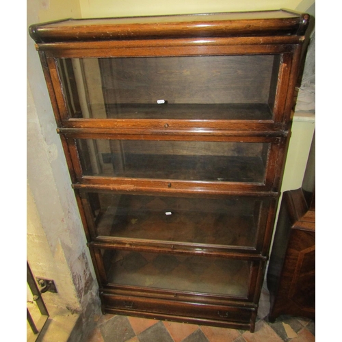 2676 - A four tier Globe Wernicke oak framed sectional bookcase with glazed up and over doors and one singl... 