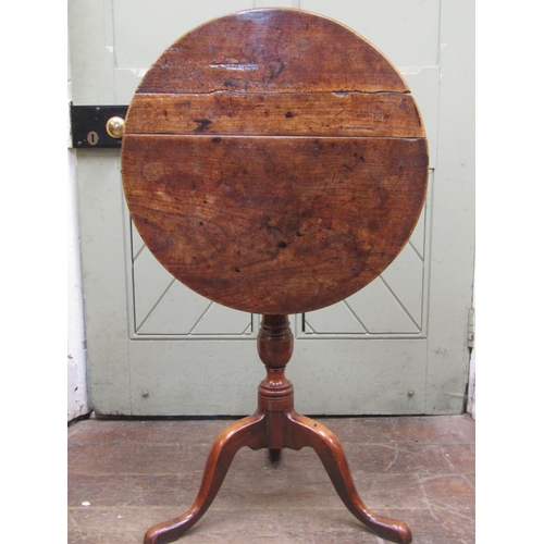 2714 - A Georgian country made snap top occasional table in fruitwood, 58 cm top raised on a vase shaped pi... 