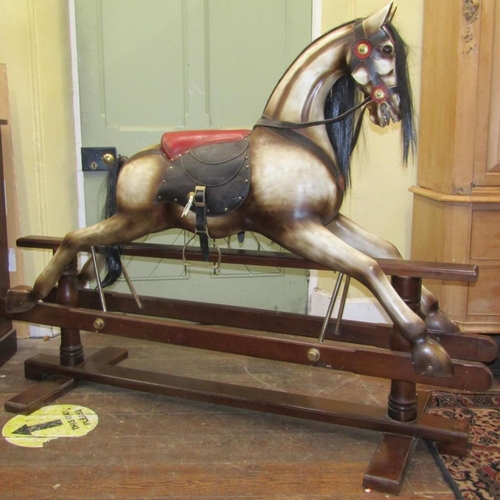 2720 - A good quality reproduction rocking horse in traditional stance and colourway with leather saddle, m... 