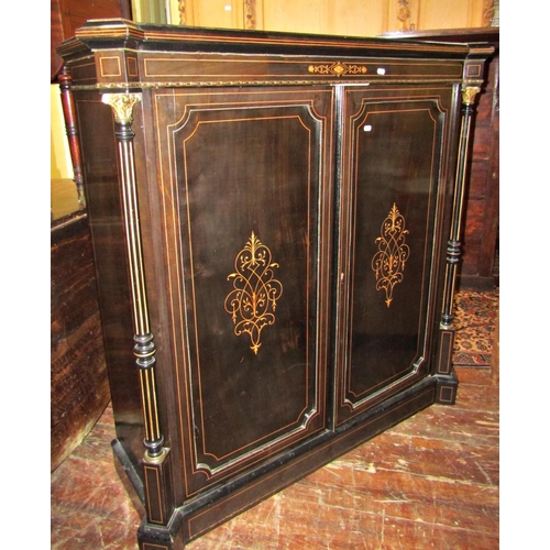 2732 - A mid Victorian period ebonised pier cabinet enclosed by two panelled doors within two reeded column... 