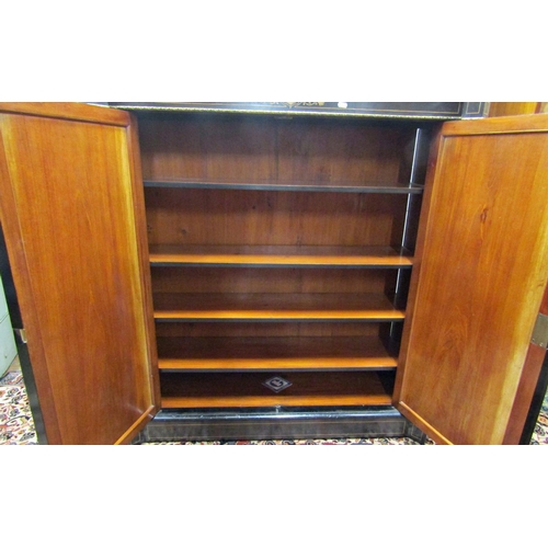 2732 - A mid Victorian period ebonised pier cabinet enclosed by two panelled doors within two reeded column... 