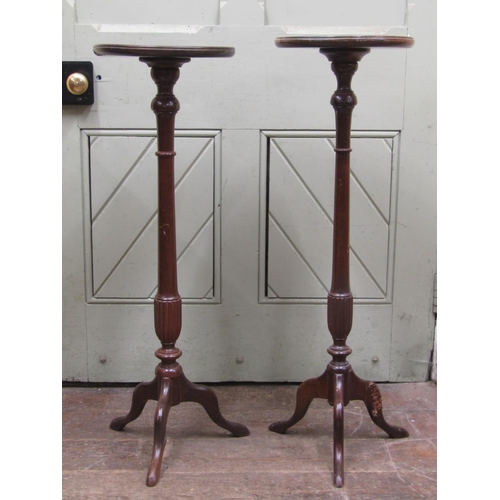 2741 - A pair of Edwardian mahogany torcheres on tripod bases, 90cm high