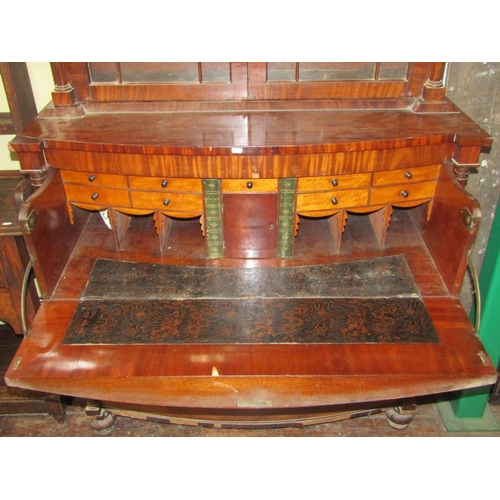 2743 - A regency mahogany secretaire bookcase, the base of bow fronted outline fitted with two deep drawers... 