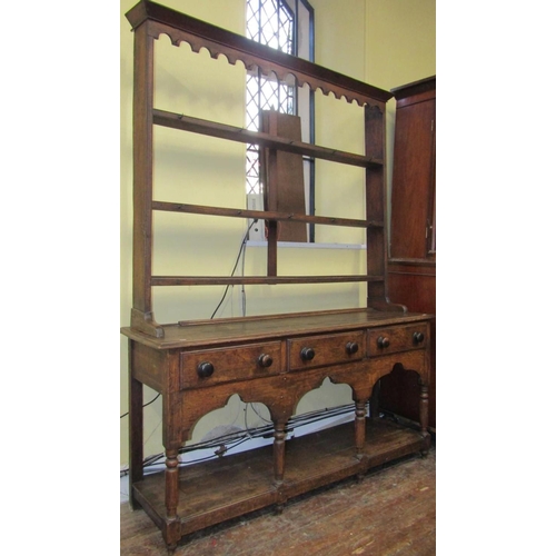 2744 - A Georgian oak cottage pot-board dresser fitted with three frieze drawers on turned supports with op... 