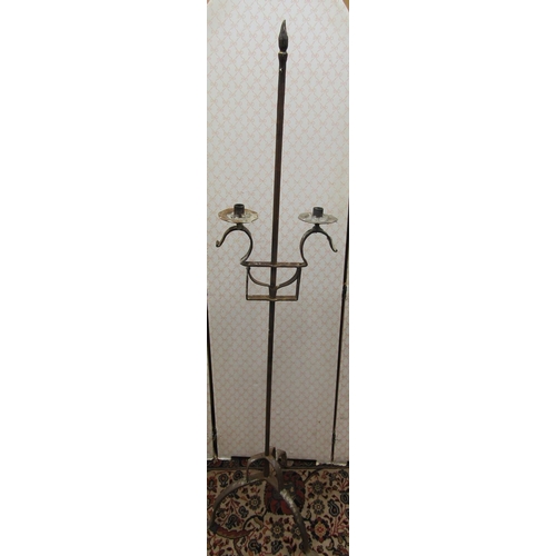 2750 - A wrought iron candle stand to support two candles, with adjustable height raised on three pad feet