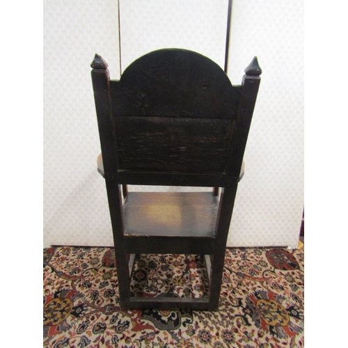 2751 - An 18th century oak elbow chair with panelled seat and back, turned supports, and rails