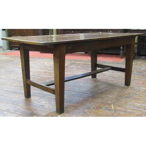 2753 - An antique oak kitchen farmhouse table, the planked top with cleated ends raised on four square tape... 